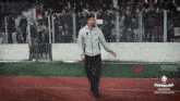 a man walking on a soccer field with a superliga insider logo on the bottom
