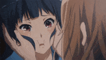 a close up of a girl 's face with her hand on it