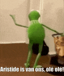 a kermit the frog is dancing in a room with the caption aristode is van ons ole ole !