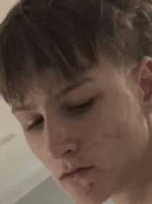 a close up of a person 's face with a nose ring