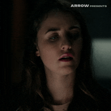 a close up of a woman 's face with arrow presents in the corner