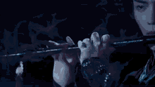 a man is standing on top of a roof holding a gun in his hand .