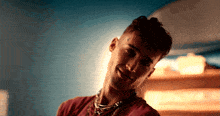 a man with a tattoo on his forehead is smiling