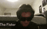 a person wearing headphones and sunglasses with the fister written on the bottom