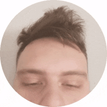 a close up of a man 's face with his eyes closed in a circle