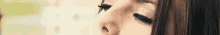 a close up of a woman 's face with her eyes closed and long eyelashes .