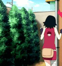 a girl in a red tank top with a red heart on her back