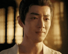 a close up of a man 's face with a sad look on his face