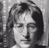 a black and white photo of a man with glasses on