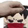 a person is petting a stuffed animal with a red scarf around his neck .