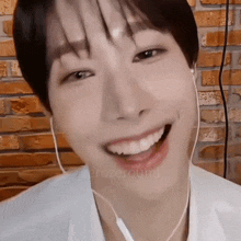 a close up of a person wearing headphones and smiling .