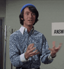 a man sticks his tongue out in front of a sign that says " answer "