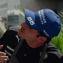 a man wearing a blue hat with the number 55