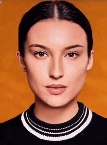 a woman wearing a black and white sweater with a striped collar