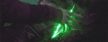 a person 's hand is touching a green light