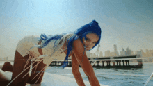 a woman with blue hair is on a boat in the water