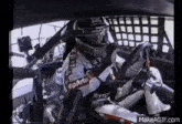 a man is sitting in a race car with a steering wheel .