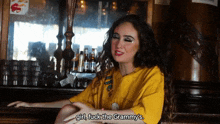 a woman wearing a yellow shirt says girl fuck the grammy 's
