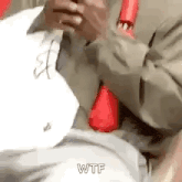 a man in a suit and tie is holding a cell phone .