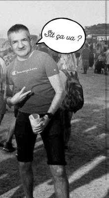a black and white photo of a man wearing a champion shirt and shorts