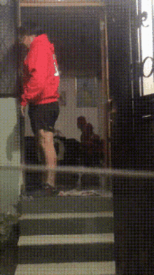 a man in a red hoodie with the number 9 on the back