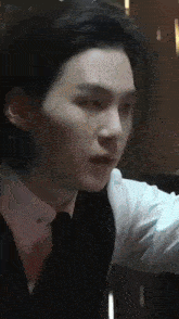 a close up of a man in a suit and tie