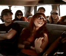 a group of people are sitting in a van and one of them has a shirt that says ahora