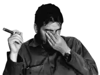 a man covering his face while holding a cigar