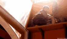 a person sitting in a box with the word creations on the bottom