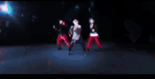 a man with blonde hair is dancing on a stage with other people .
