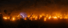 a city is on fire with a purple light coming out of the sky .
