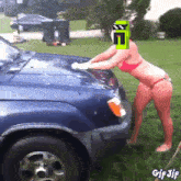 a woman in a bikini is washing a truck with a gif jif watermark at the bottom