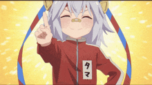 a girl with a bandage on her nose is wearing a red jacket that says tama