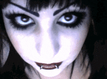 a close up of a woman 's face with piercings on her lips