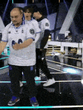 a man in a kappa shirt is dancing with other men