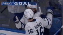 a hockey player with the number 16 on his jersey is celebrating a goal