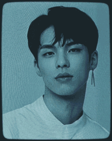 a black and white photo of a young man with a white shirt