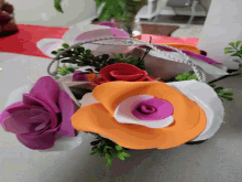 a bunch of different colored flowers in a basket