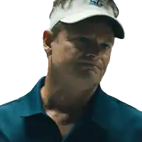a man wearing a blue shirt and a white hat with the letters sg on it