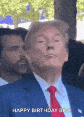 a man in a blue suit and red tie says " happy birthday bro "
