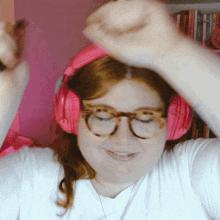 a woman wearing headphones and glasses is dancing