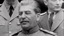 a man with a mustache is smiling in a black and white photo taken by showtime