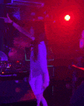 a woman is singing into a microphone in front of a pioneer dj machine