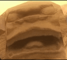 a close up of a piece of brown paper with a hole in it