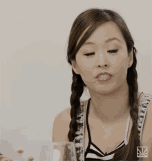 a woman with braids is making a face and says why not .
