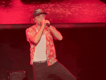 a man singing into a microphone wearing a hat that says california on it