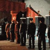 a group of men standing in front of a stage with trophies