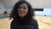 a woman wearing a black jacket that says quechua on the front