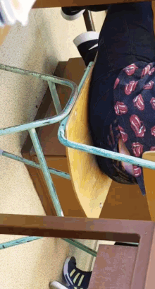 a person in a rolling stones shirt sits at a desk