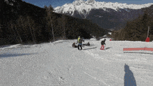 a group of people skiing down a snowy mountain